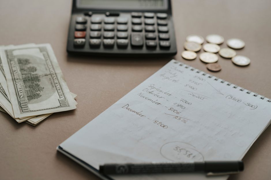 Calculator, cash, coins, and notes arranged for thoughtful financial planning